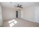 Spacious bedroom with carpeted floors, ceiling fan, and two closets at 550 Davis Rd, Fayetteville, GA 30215