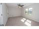 Bright bedroom with neutral walls, carpeted floor, and ceiling fan at 550 Davis Rd, Fayetteville, GA 30215