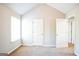 Bright bedroom with neutral walls and carpet, featuring a large window and ample closet space at 4626 Derby Loop, Fairburn, GA 30213