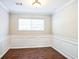 Formal dining room with wainscoting and hardwood floors at 4626 Derby Loop, Fairburn, GA 30213