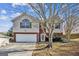Two-story house with a brick and siding exterior, attached garage, and landscaping at 4626 Derby Loop, Fairburn, GA 30213