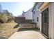 Rear view of a house showing a patio, door, and sloped yard at 4626 Derby Loop, Fairburn, GA 30213