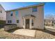 Two-story house with beige siding, multiple windows, and a small patio area at 4626 Derby Loop, Fairburn, GA 30213
