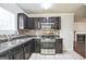 Updated kitchen features dark wood cabinets and stainless steel appliances at 4626 Derby Loop, Fairburn, GA 30213