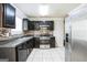 Kitchen with dark wood cabinets, tile backsplash, and stainless steel appliances at 4626 Derby Loop, Fairburn, GA 30213