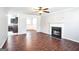 Living room featuring hardwood floors, fireplace, and view into kitchen at 4626 Derby Loop, Fairburn, GA 30213