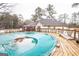 Above ground pool with wooden deck and pool cover at 3176 Pope Rd, Douglasville, GA 30135