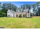 Two story white farmhouse with large green lawn at 3641 Pennington Se Dr, Conyers, GA 30013