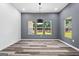 Bright dining room with gray accent wall and hardwood floors at 3641 Pennington Se Dr, Conyers, GA 30013