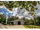 Rustic barn with double doors and a basketball goal, surrounded by trees at 183 Madden Rd, Bowdon, GA 30108