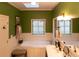 Elegant bathroom with a soaking tub, double vanity, and stained-glass windows at 183 Madden Rd, Bowdon, GA 30108