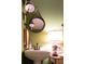 Charming bathroom with a pedestal sink and a round mirror at 183 Madden Rd, Bowdon, GA 30108