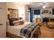 Cozy bedroom with a king-size bed, plaid bedding, and a sitting area at 183 Madden Rd, Bowdon, GA 30108