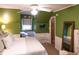 Spacious bedroom with king-size bed and calming green walls at 183 Madden Rd, Bowdon, GA 30108