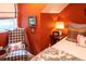 Cozy bedroom with a comfy chair and burnt orange walls at 183 Madden Rd, Bowdon, GA 30108