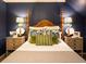 Charming bedroom with a wooden four-poster bed and blue walls at 183 Madden Rd, Bowdon, GA 30108