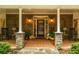 Brick porch with rocking chairs and autumn decor at 183 Madden Rd, Bowdon, GA 30108