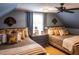 Upstairs guest bedroom with two twin beds, ample pillows, and decorative wall hangings at 183 Madden Rd, Bowdon, GA 30108
