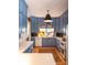 Modern kitchen featuring light blue cabinets and white appliances at 183 Madden Rd, Bowdon, GA 30108