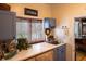 Bright laundry room with a utility sink and plenty of cabinet storage at 183 Madden Rd, Bowdon, GA 30108