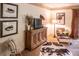 Living room with a rustic wooden cabinet, comfortable seating, and artwork at 183 Madden Rd, Bowdon, GA 30108