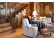 Cozy sitting area with wooden staircase, comfortable armchairs, and ottoman at 183 Madden Rd, Bowdon, GA 30108