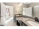 Bathroom with granite countertop, double sinks, and a view of a bedroom at 613 Cork St, Woodstock, GA 30188