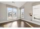 Bright bedroom with hardwood floors and large windows overlooking a deck at 613 Cork St, Woodstock, GA 30188