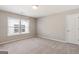 Bright bedroom with neutral walls and carpet at 613 Cork St, Woodstock, GA 30188