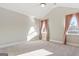Spacious bedroom with vaulted ceilings, carpeting, and ceiling fan at 613 Cork St, Woodstock, GA 30188