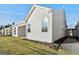 White house exterior with covered patio and grassy yard at 613 Cork St, Woodstock, GA 30188