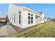 White house exterior with covered patio and grassy yard at 613 Cork St, Woodstock, GA 30188
