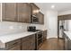 Modern kitchen features gray cabinets, white quartz countertops, and stainless steel appliances at 613 Cork St, Woodstock, GA 30188