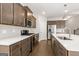 Kitchen with stainless steel appliances, gray cabinets, and an island with white quartz countertops at 613 Cork St, Woodstock, GA 30188