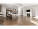 Open living room and kitchen with hardwood floors and a fireplace at 613 Cork St, Woodstock, GA 30188