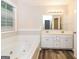 Bathroom features a double vanity, soaking tub, and tile flooring at 1949 Greensbrooke Close, Stone Mountain, GA 30088