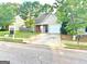 Ranch style home with a two-car garage and attractive landscaping at 261 Coral Cir, Mcdonough, GA 30253