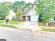 Ranch style home with a two-car garage and attractive landscaping at 261 Coral Cir, Mcdonough, GA 30253