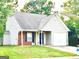 Brick and vinyl ranch home with attached garage and landscaped lawn at 261 Coral Cir, Mcdonough, GA 30253