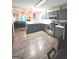 Open kitchen with gray cabinets, island, and stainless steel appliances at 261 Coral Cir, Mcdonough, GA 30253