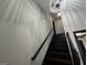 Modern staircase with black railings and crystal chandelier at 172 Oak Forest Se Dr, Smyrna, GA 30082