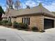 Brick home with stone accents, black garage door, and landscaping at 232 Darwish Dr, Mcdonough, GA 30252