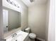Clean bathroom with a sink, toilet, and a vanity mirror at 4436 Malibu Dr, Decatur, GA 30035