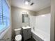 Updated bathroom with gray vanity, tub, and shower at 10178 Allen Sw Dr, Covington, GA 30014