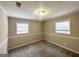 Well-lit bedroom featuring neutral walls, carpet, and window at 10178 Allen Sw Dr, Covington, GA 30014