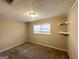 Cozy bedroom with neutral decor, carpet, and built-in shelving at 10178 Allen Sw Dr, Covington, GA 30014