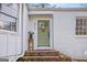 Quaint green front door and brick steps of a white brick home at 311 Burke Cir, Mcdonough, GA 30253