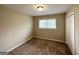 Spacious bedroom with neutral walls, plush carpeting, and a double door closet at 3975 Phylis Pl, Decatur, GA 30035