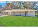 Ranch style home with brick facade, covered porch, and well-manicured lawn at 3975 Phylis Pl, Decatur, GA 30035