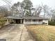 Brick ranch home with carport, covered porch, and a spacious yard at 3975 Phylis Pl, Decatur, GA 30035